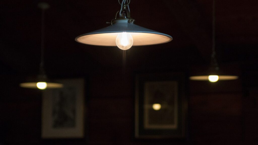 Do smart bulbs work without wifi: a pendant lamp still lit over a dining table