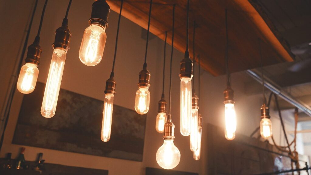 Philips Hue vs LIFX vs Govee: a row of warm smart bulbs hanging side by side